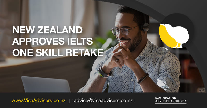A man sits in front of a computer with a joyful expression on his face, indicating he's delighted by the news that New Zealand has approved the retake of a single skill in the IELTS (International English Language Testing System) exam.